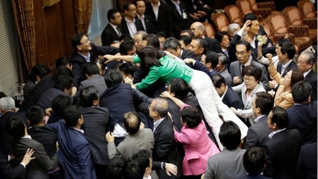 Các nghị sĩ bao vây chủ tịch ủy ban sau khi luật được thông qua. (Ảnh: AP)